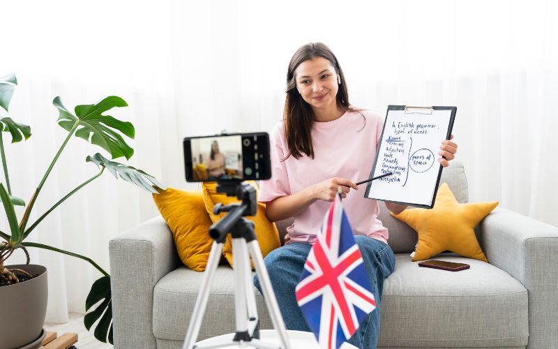 a woman sitting on a couch holding a clipboard and a pen